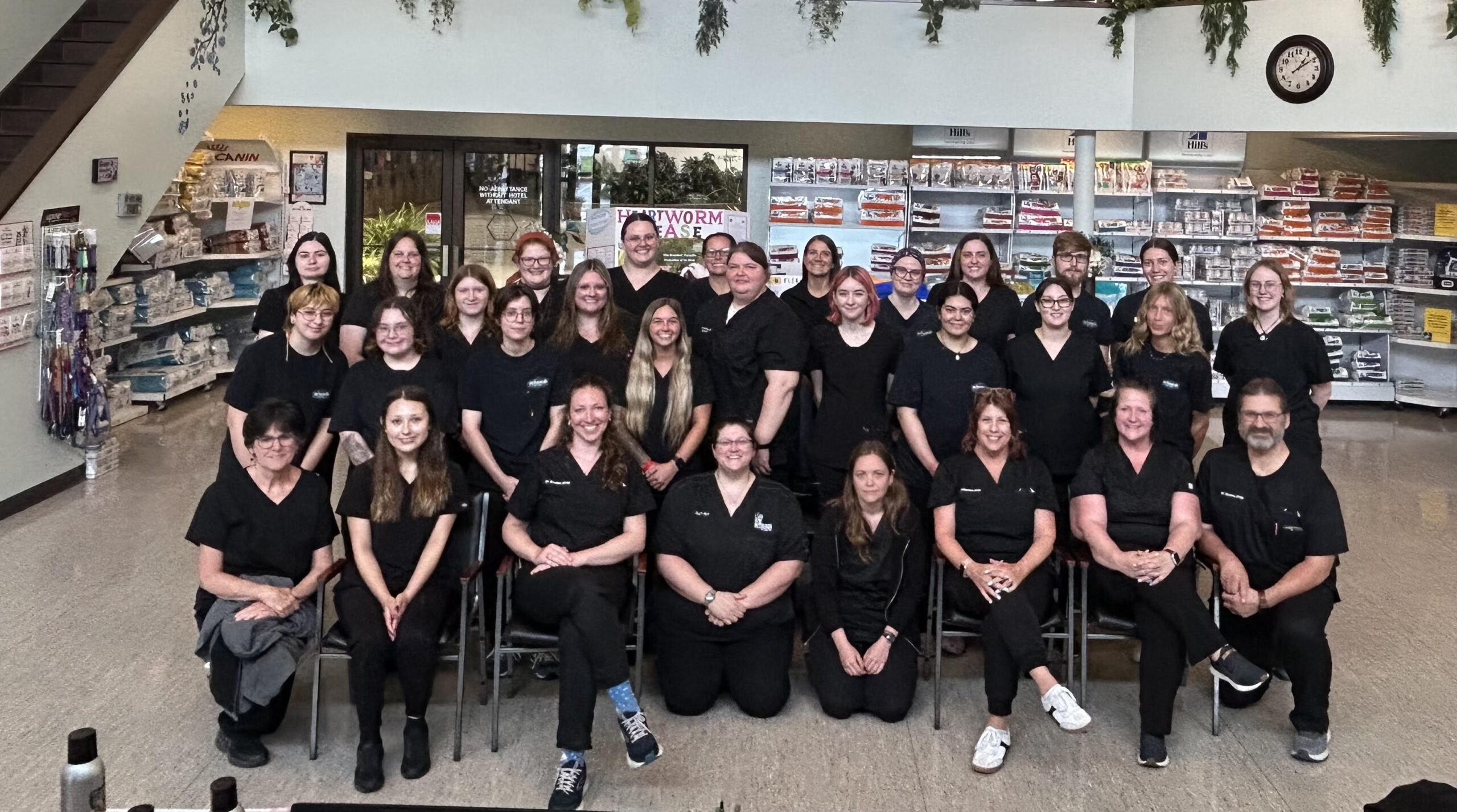 grouppic The entire vet team of Petsburgh Pet Care in Lafayette, IN standing in front of the building wearing black